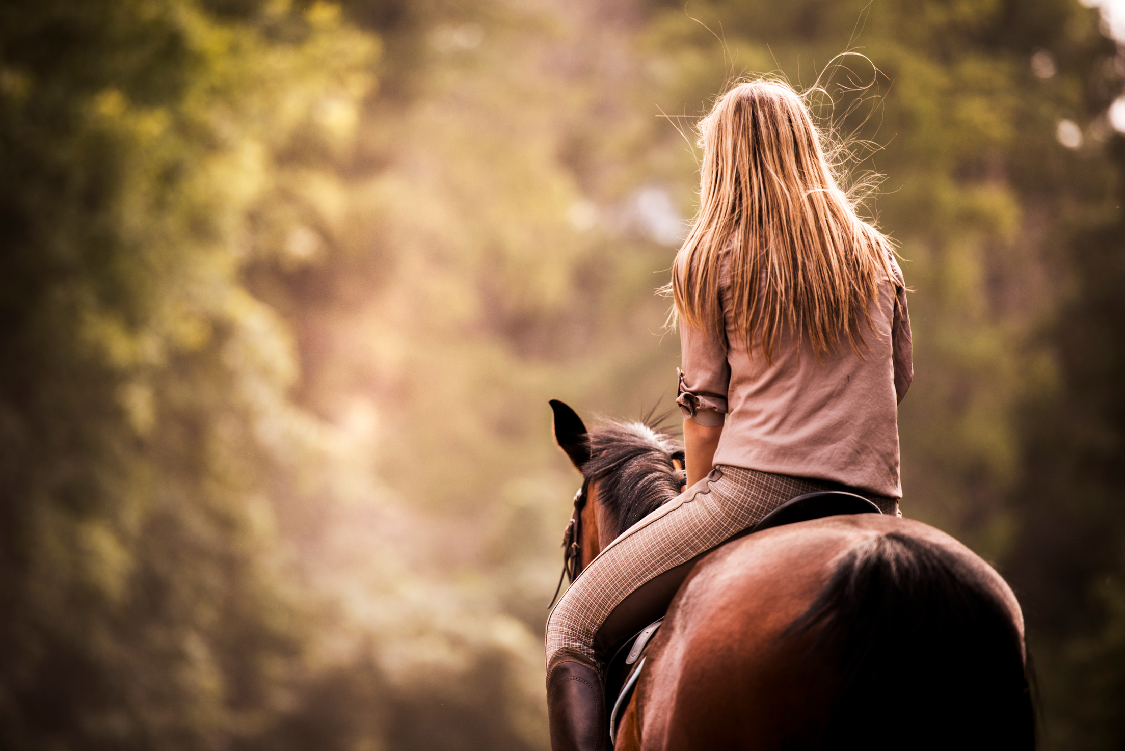 Woman horseback riding.